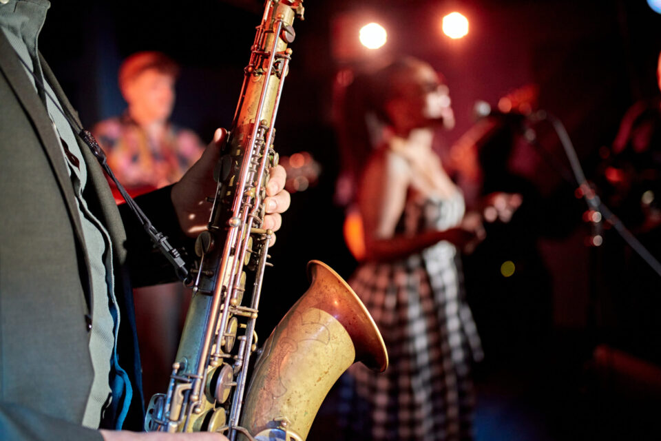 close up of jazz saxophonist onstage with band